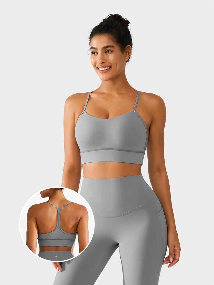 A model wearing a BRXL® Flow Y Racerback Bra with Low Cut and Spaghetti Straps in