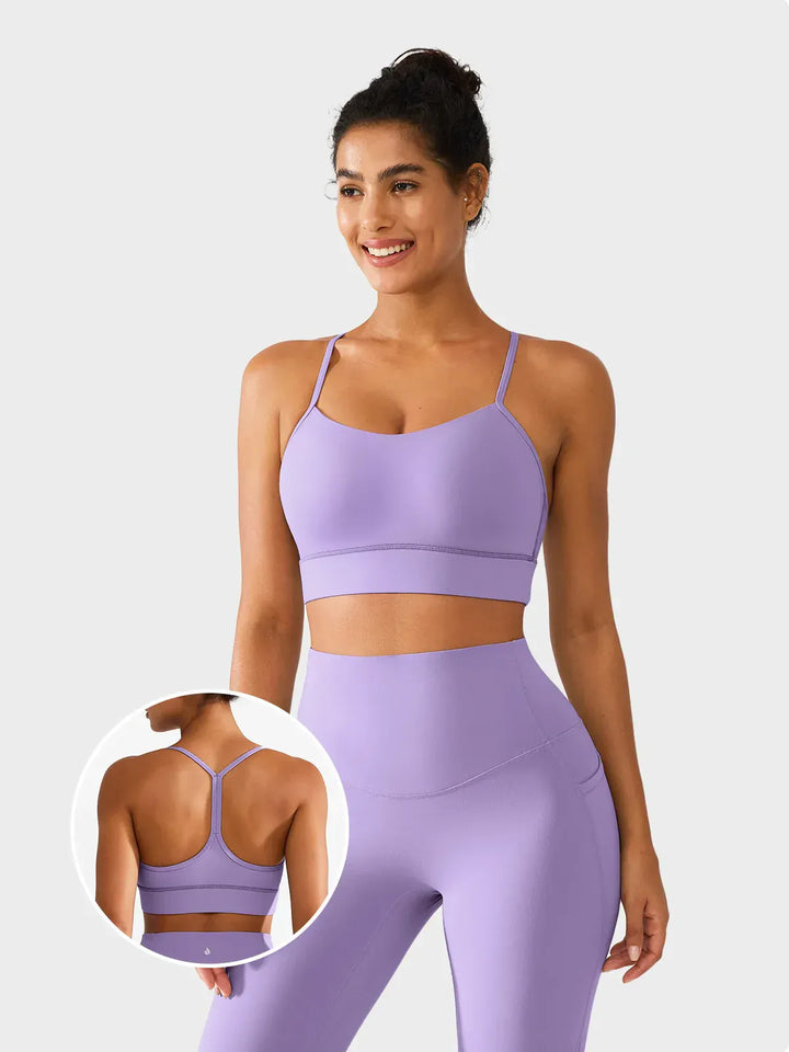 A model wearing a BRXL® Flow Y Racerback Bra with Low Cut and Spaghetti Straps in