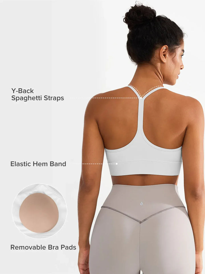 A model wearing a BRXL® Flow Y Racerback Bra with Low Cut and Spaghetti Straps