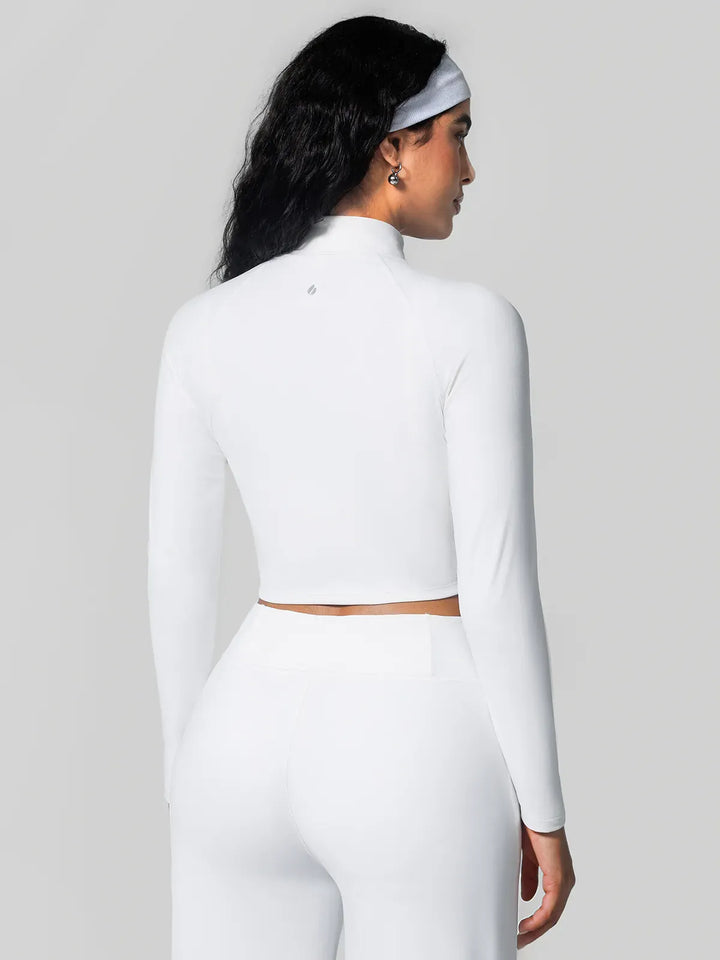 A model wearing a BRXL® Half Front Zipper Activewear Cropped Top in