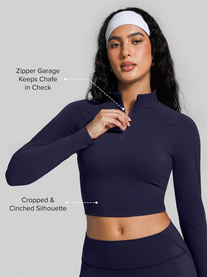 A model wearing a BRXL® Half Front Zipper Activewear Cropped Top in