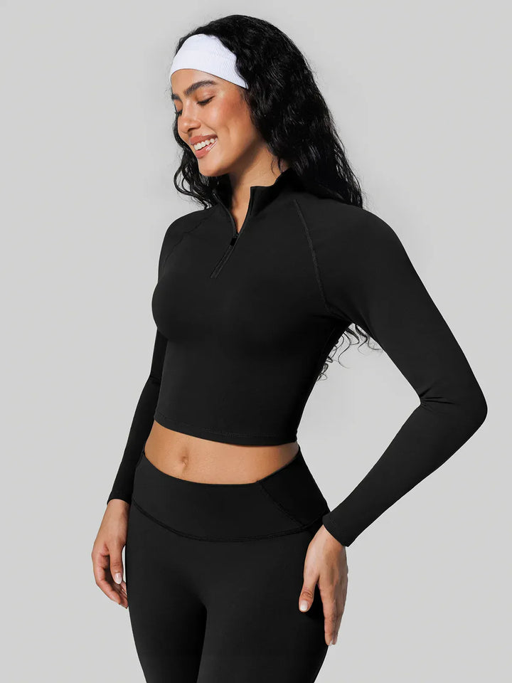 A model wearing a BRXL® Half Front Zipper Activewear Cropped Top in