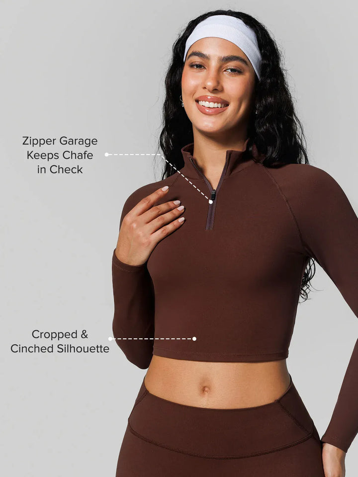 A model wearing a BRXL® Half Front Zipper Activewear Cropped Top in