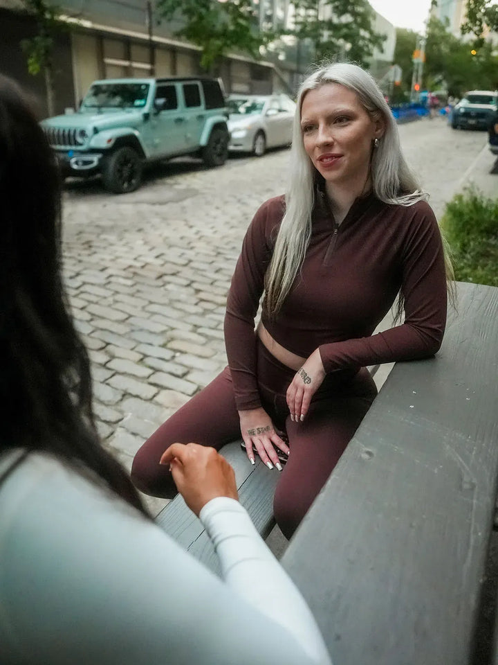 A model wearing a BRXL® Half Front Zipper Activewear Cropped Top in