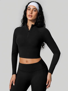 A model wearing a BRXL® Half Front Zipper Activewear Cropped Top in Black / XS