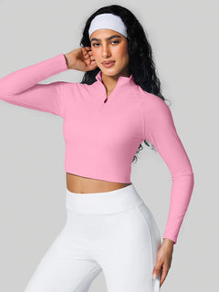 A model wearing a BRXL® Half Front Zipper Activewear Cropped Top in Pink / XS