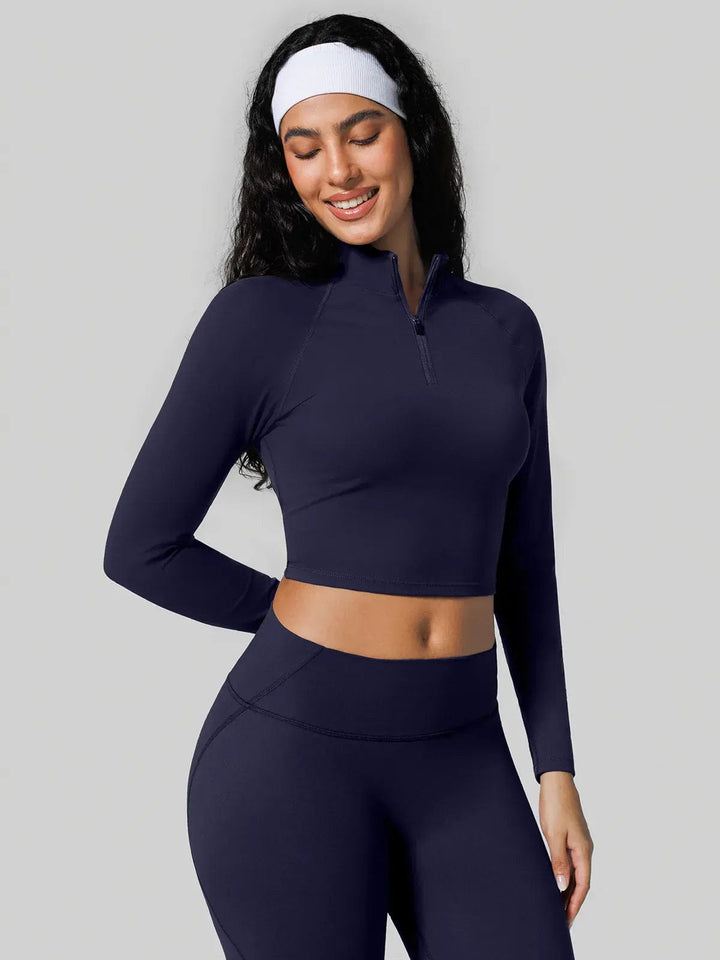 A model wearing a BRXL® Half Front Zipper Cropped Top Seamless Butt-Lifting Leggings Set in