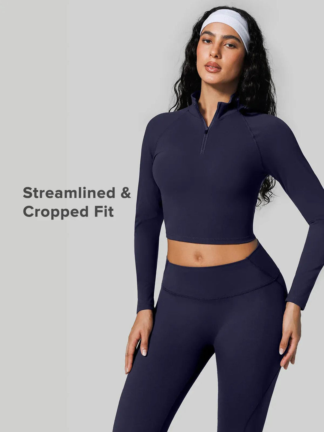 A model wearing a BRXL® Half Front Zipper Cropped Top Seamless Butt-Lifting Leggings Set in