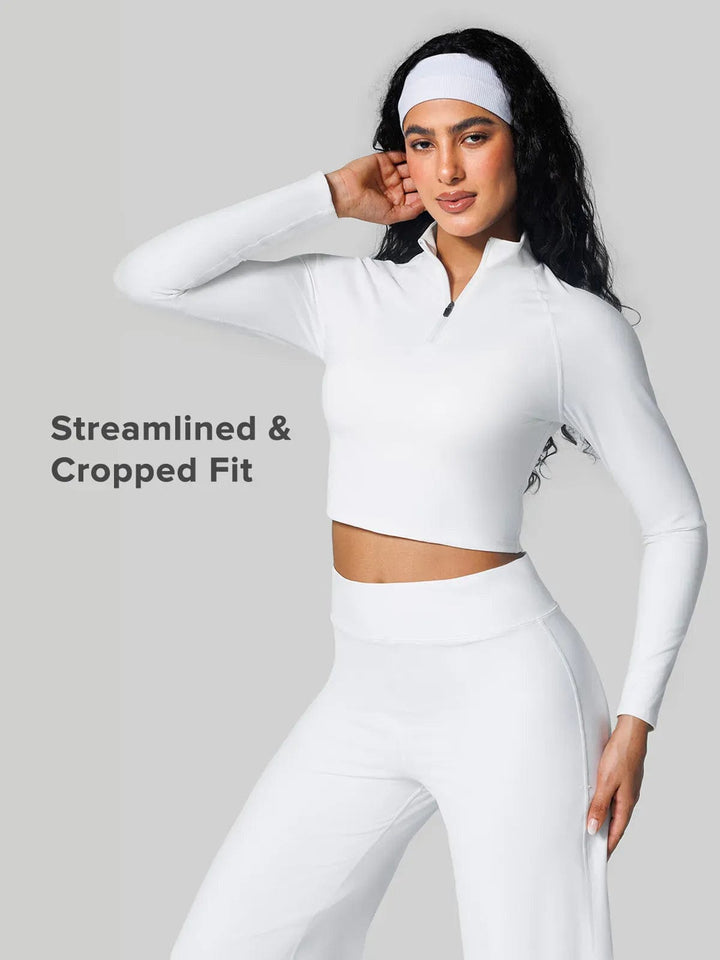 A model wearing a BRXL® Half Front Zipper Cropped Top Seamless Butt-Lifting Leggings Set in