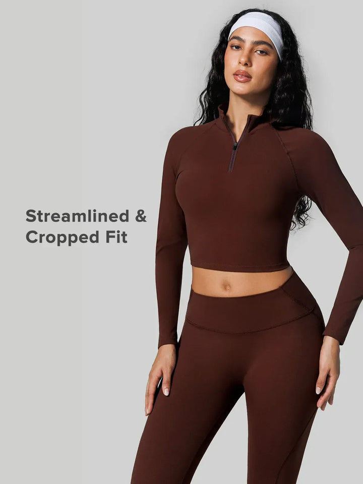 A model wearing a BRXL® Half Front Zipper Cropped Top Seamless Butt-Lifting Leggings Set in