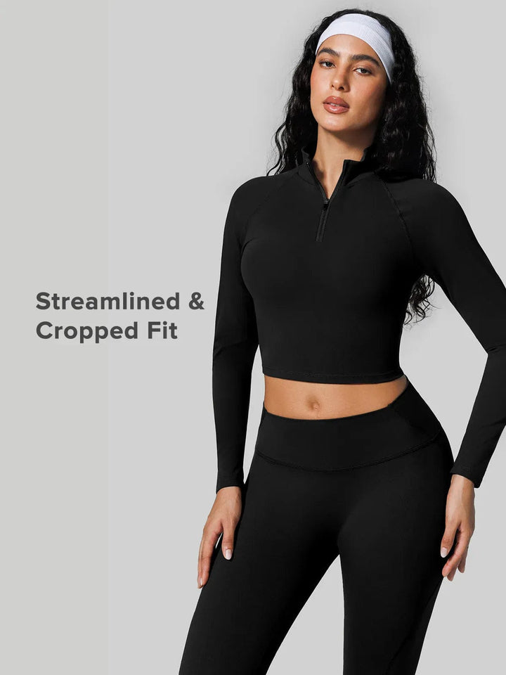 A model wearing a BRXL® Half Front Zipper Cropped Top Seamless Butt-Lifting Leggings Set in