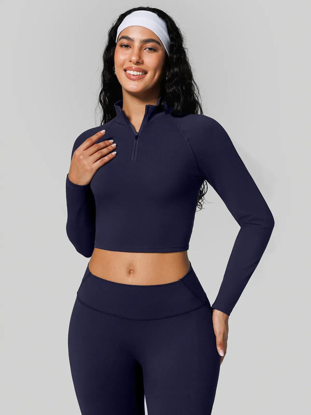 A model wearing a BRXL® Half Front Zipper Cropped Top Seamless Butt-Lifting Leggings Set in
