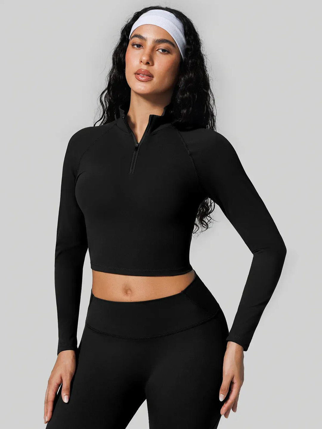 A model wearing a BRXL® Half Front Zipper Cropped Top Seamless Butt-Lifting Leggings Set in Top / Black / XS