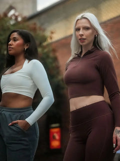 A model wearing a BRXL® Half Front Zipper Cropped Top Seamless High Waisted Leggings Set in