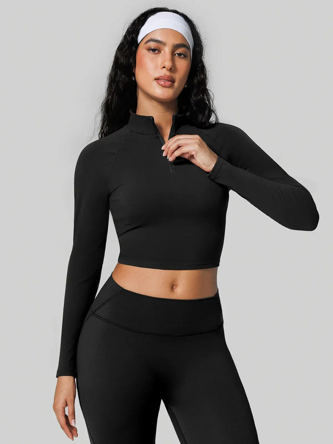 A model wearing a BRXL® Half Front Zipper Cropped Top Seamless High Waisted Leggings Set in