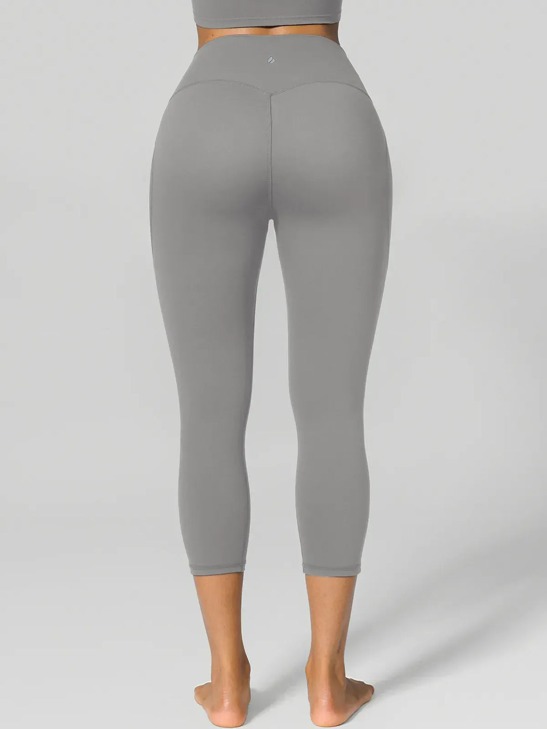 A model wearing a BRXL® Half Front Zipper Cropped Top Side Pockets Fleece Lined Leggings Set in