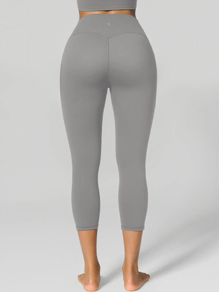 A model wearing a BRXL® Half Front Zipper Cropped Top Side Pockets Fleece Lined Leggings Set in