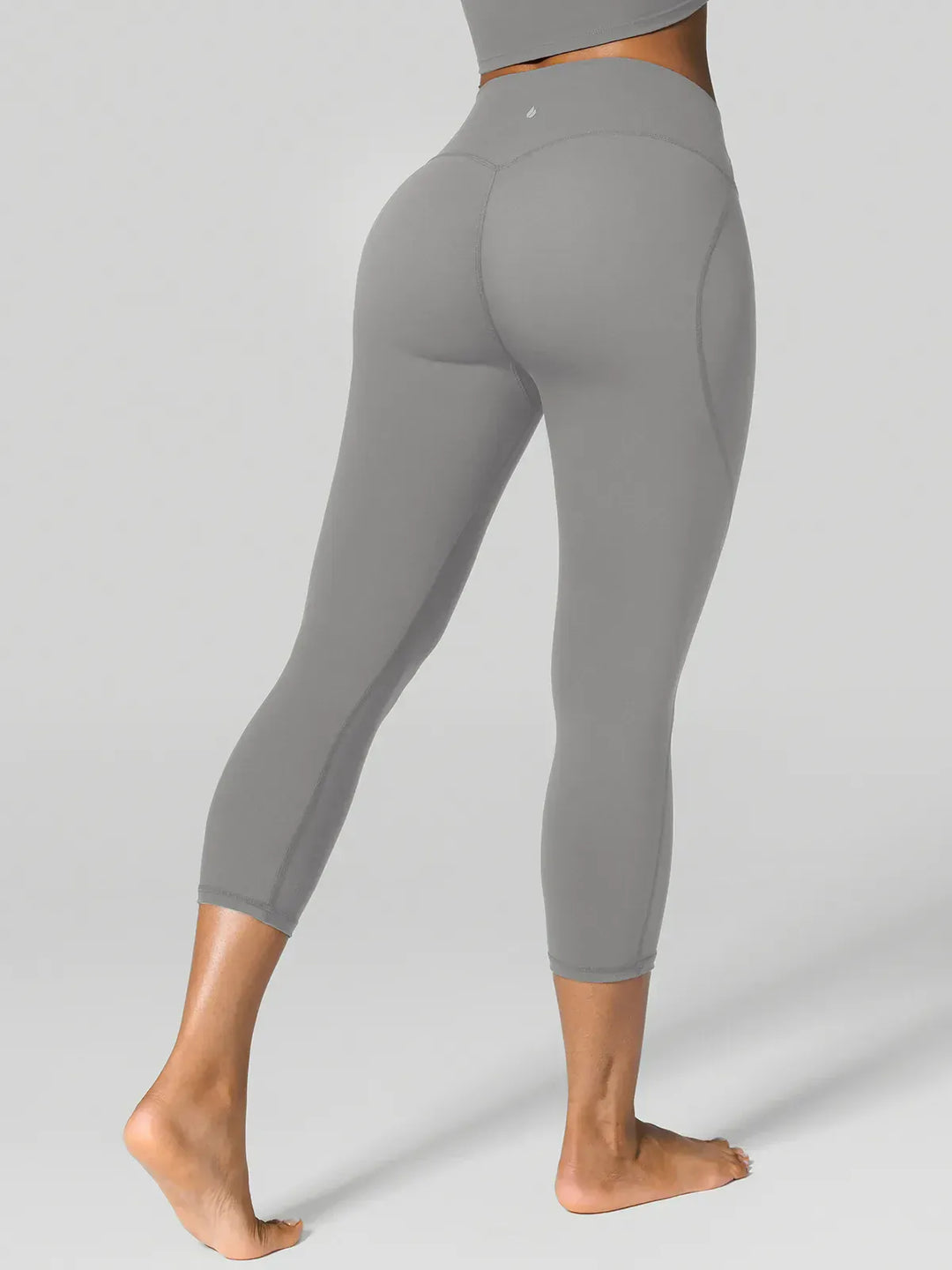 A model wearing a BRXL® Half Front Zipper Cropped Top Side Pockets Fleece Lined Leggings Set in