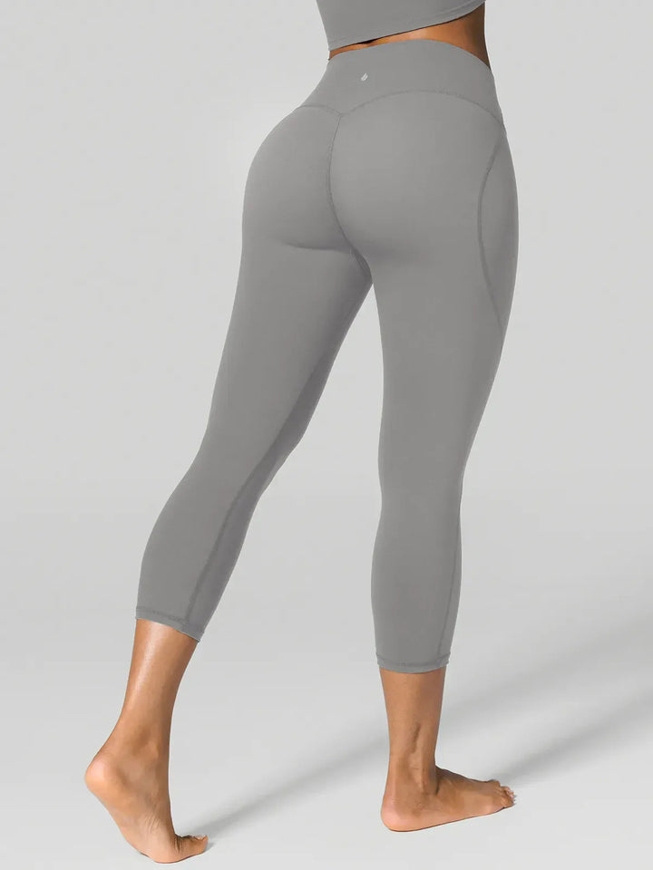 A model wearing a BRXL® Half Front Zipper Cropped Top Side Pockets Fleece Lined Leggings Set in