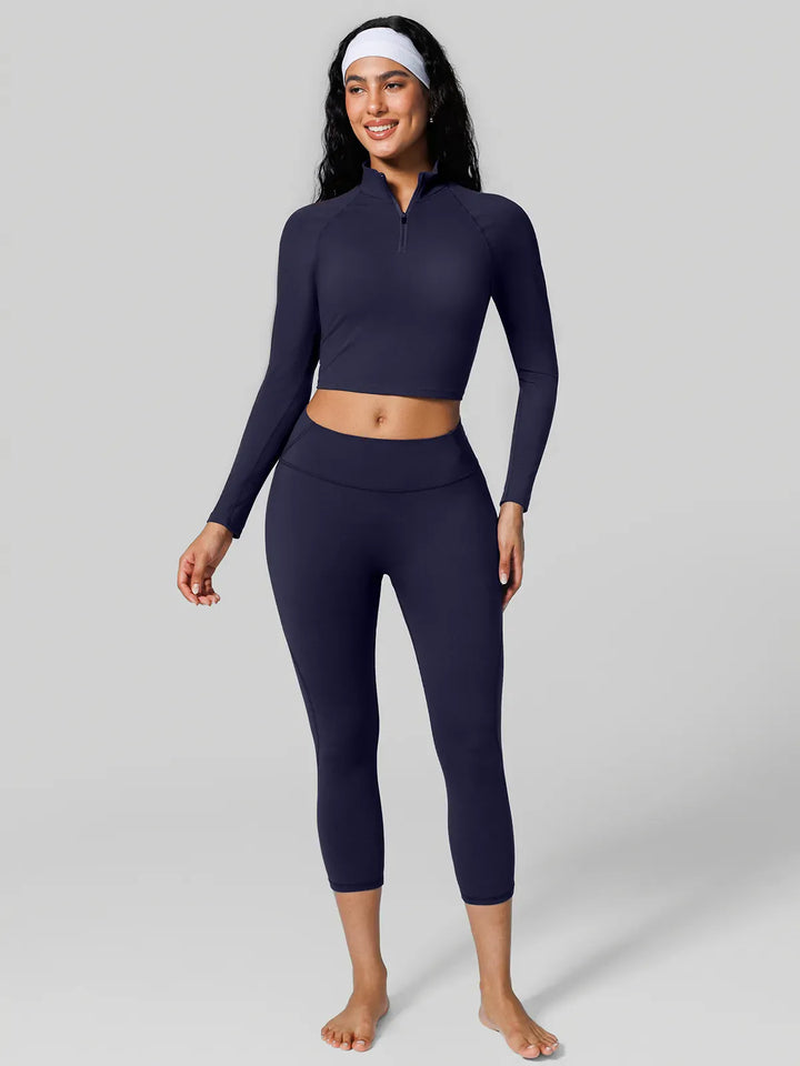 A model wearing a BRXL® Half Front Zipper Cropped Top Side Pockets Fleece Lined Leggings Set in