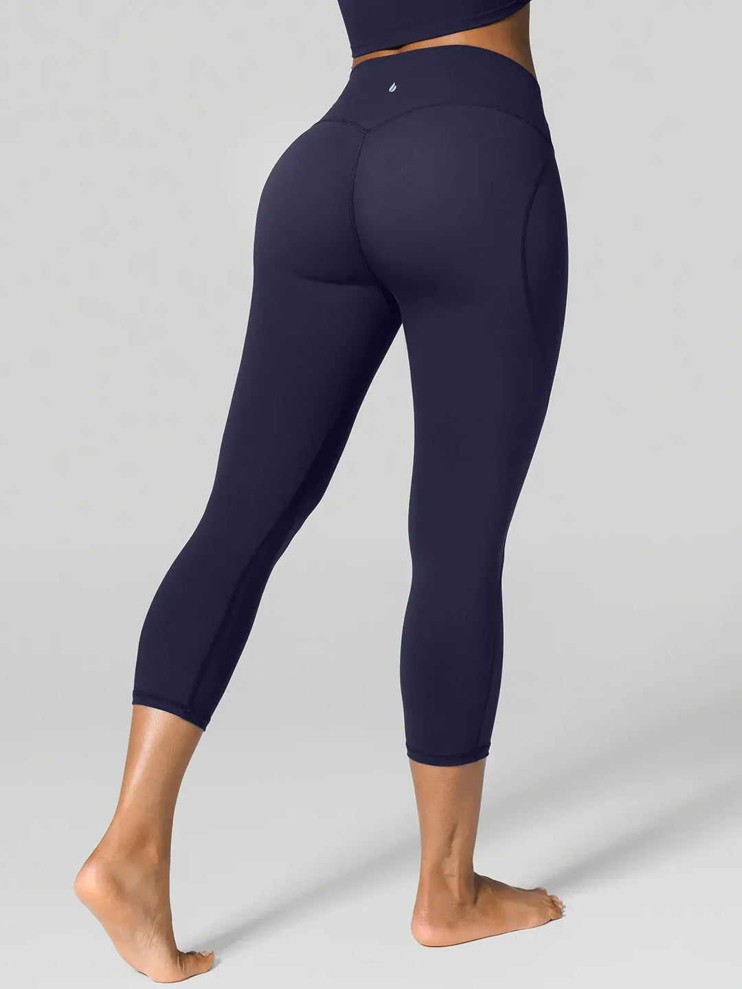 A model wearing a BRXL® Half Front Zipper Cropped Top Side Pockets Fleece Lined Leggings Set in