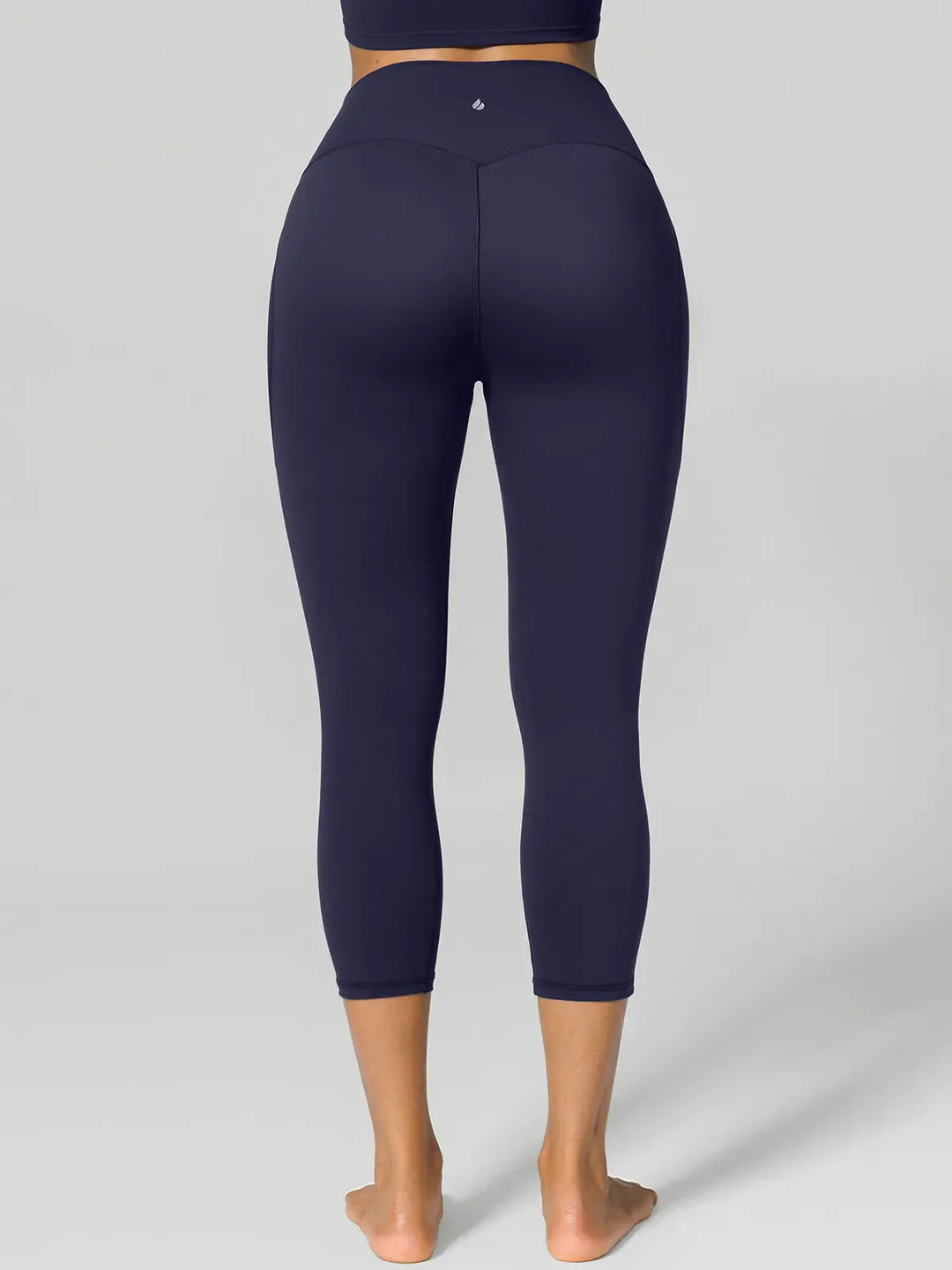 A model wearing a BRXL® Half Front Zipper Cropped Top Side Pockets Fleece Lined Leggings Set in