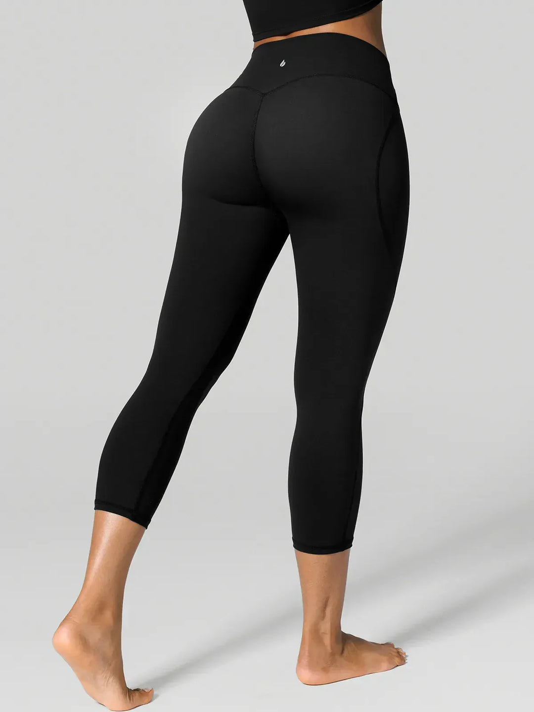A model wearing a BRXL® Half Front Zipper Cropped Top Side Pockets Fleece Lined Leggings Set in