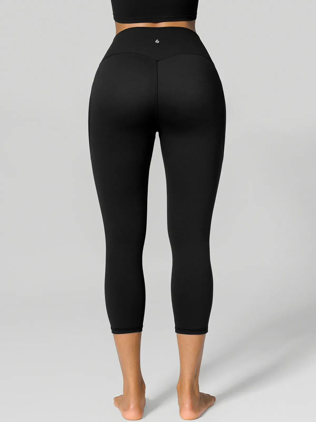 A model wearing a BRXL® Half Front Zipper Cropped Top Side Pockets Fleece Lined Leggings Set in