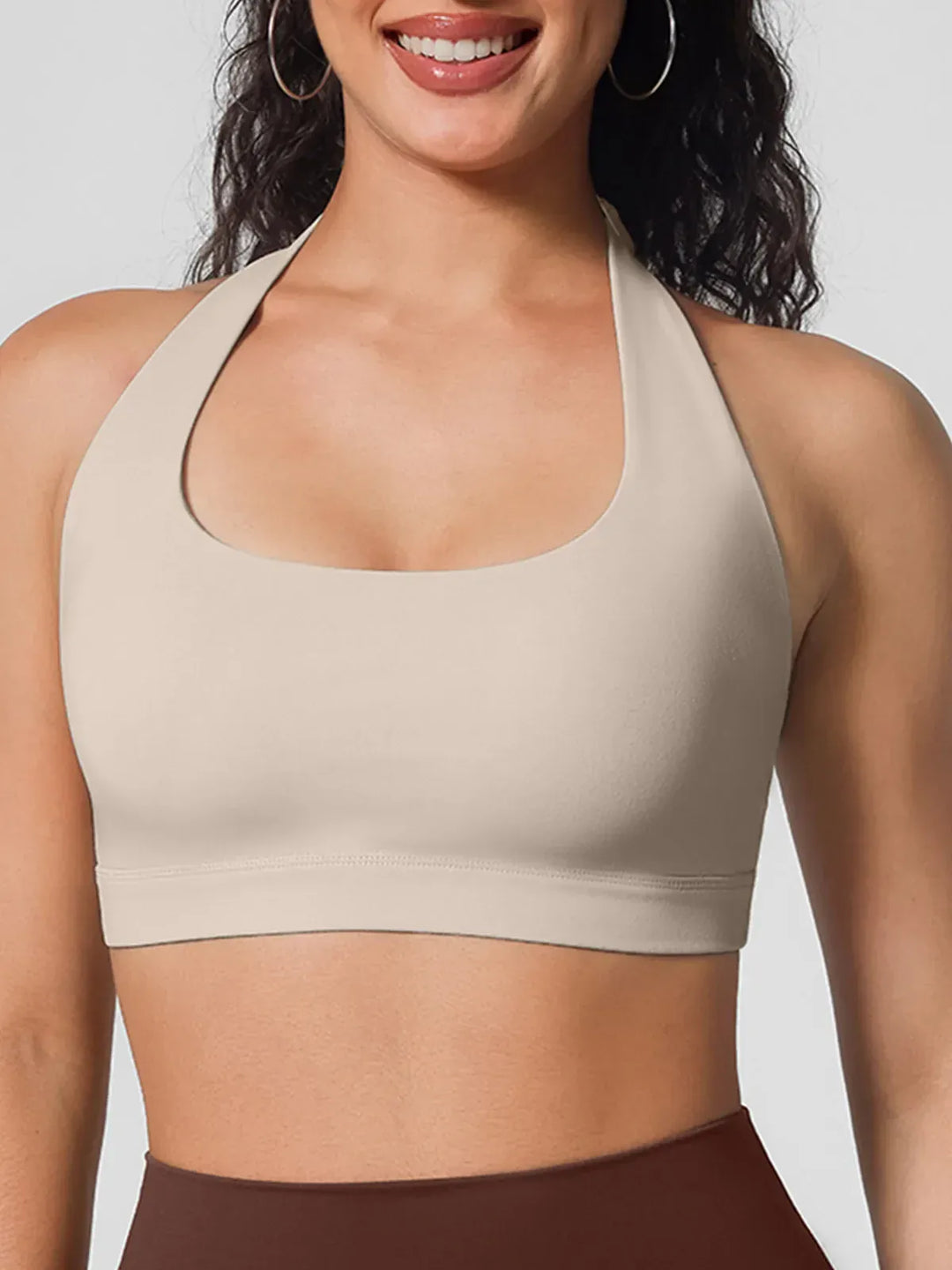 A model wearing a BRXL® Halter-neck Yoga Bra in