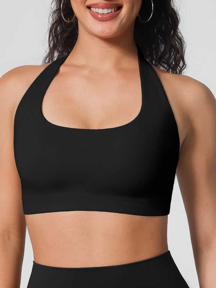 A model wearing a BRXL® Halter-neck Yoga Bra in