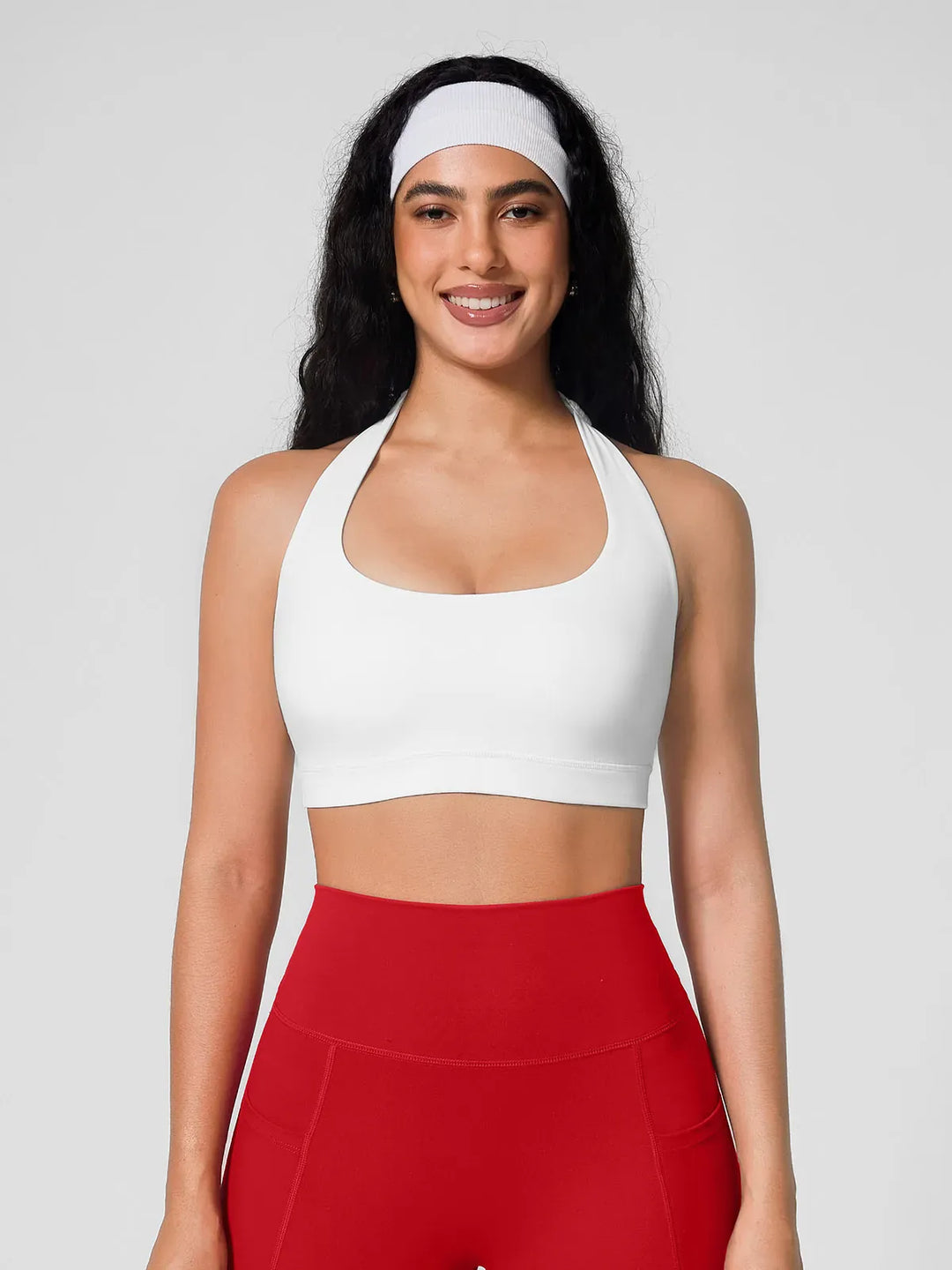 A model wearing a BRXL® Halter-neck Yoga Bra in