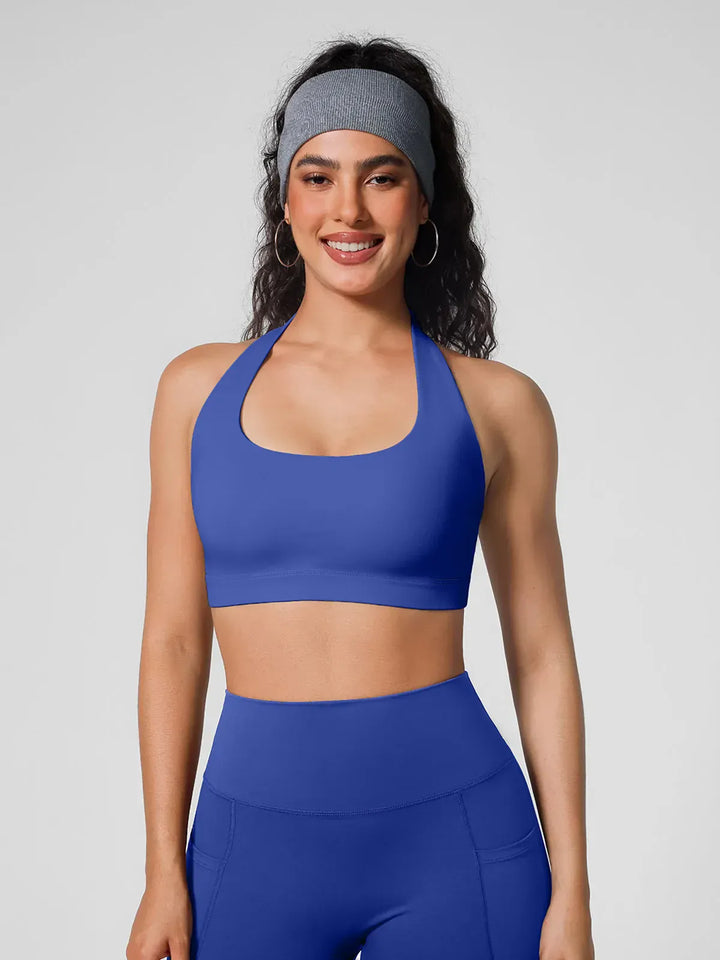 A model wearing a BRXL® Halter-neck Yoga Bra in