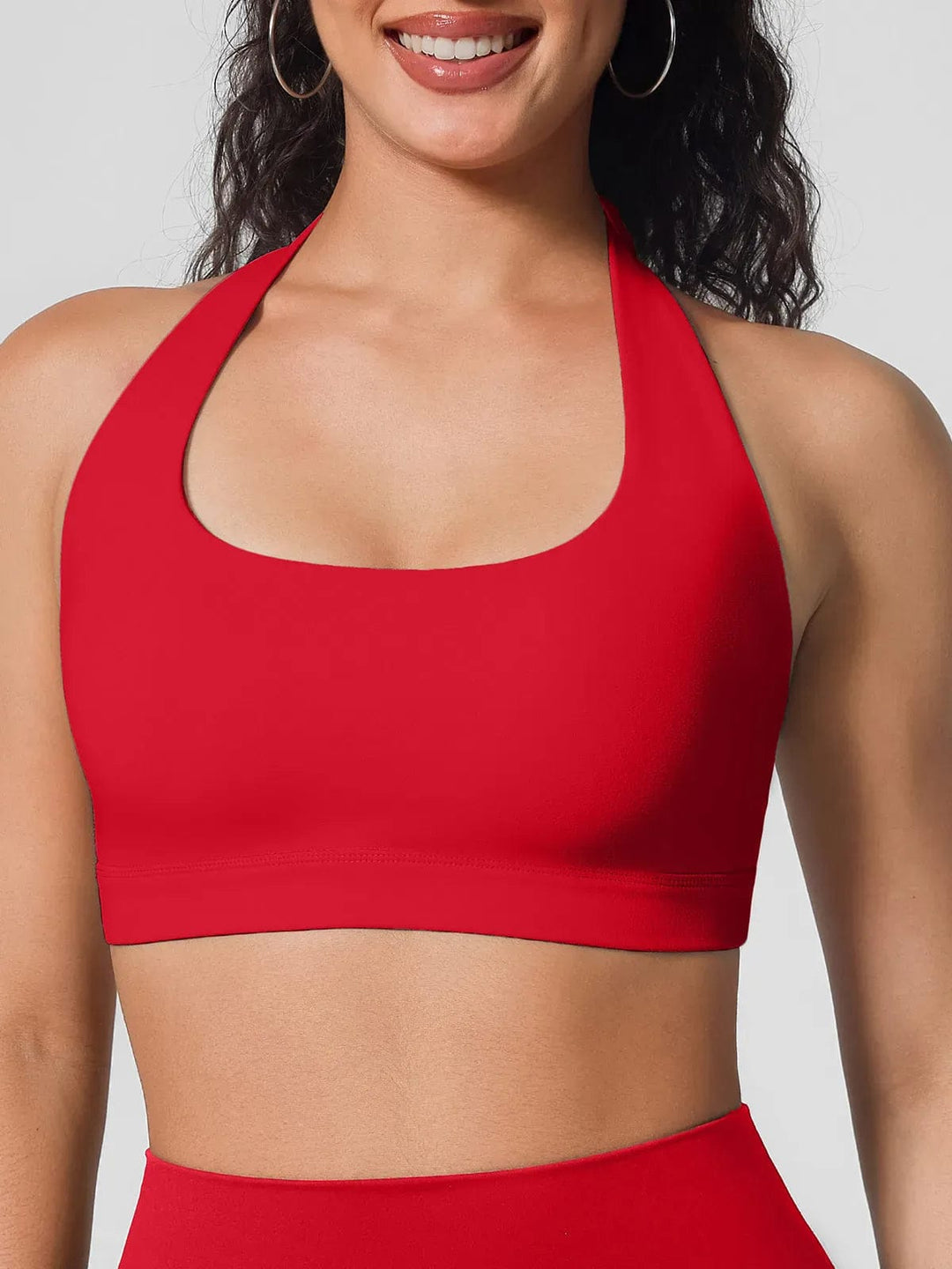 A model wearing a BRXL® Halter-neck Yoga Bra,High Rise Flared Side Pockets Scrunch Leggings in