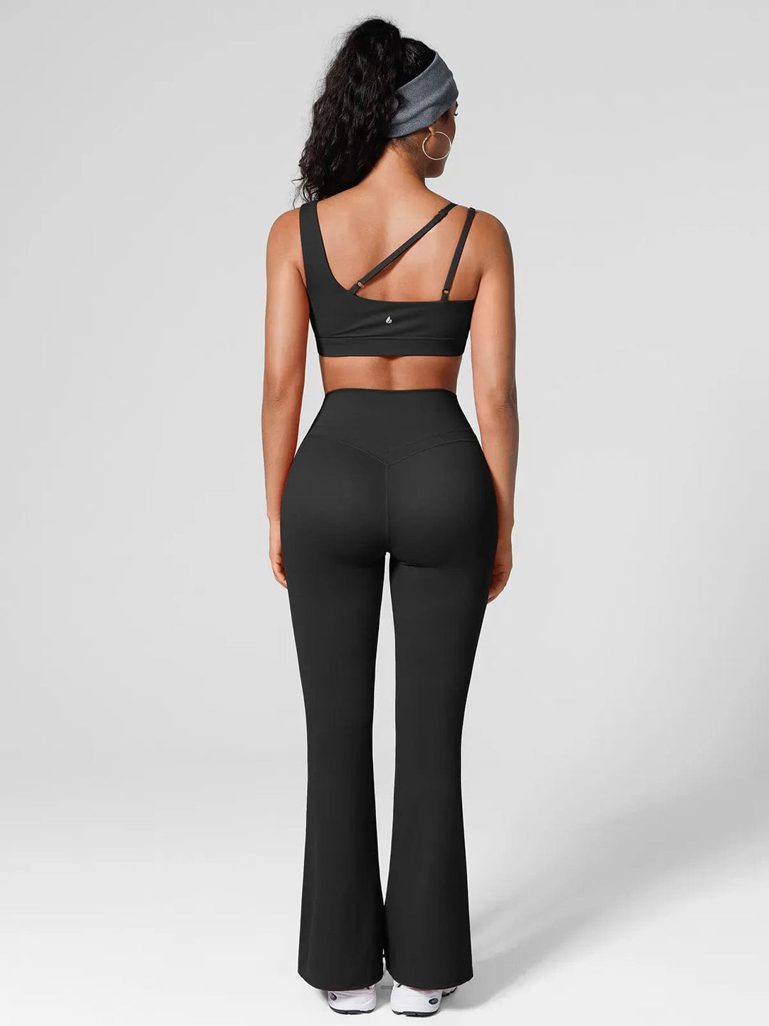 A model wearing a BRXL® Halter-neck Yoga Bra,High Rise Flared Side Pockets Scrunch Leggings in