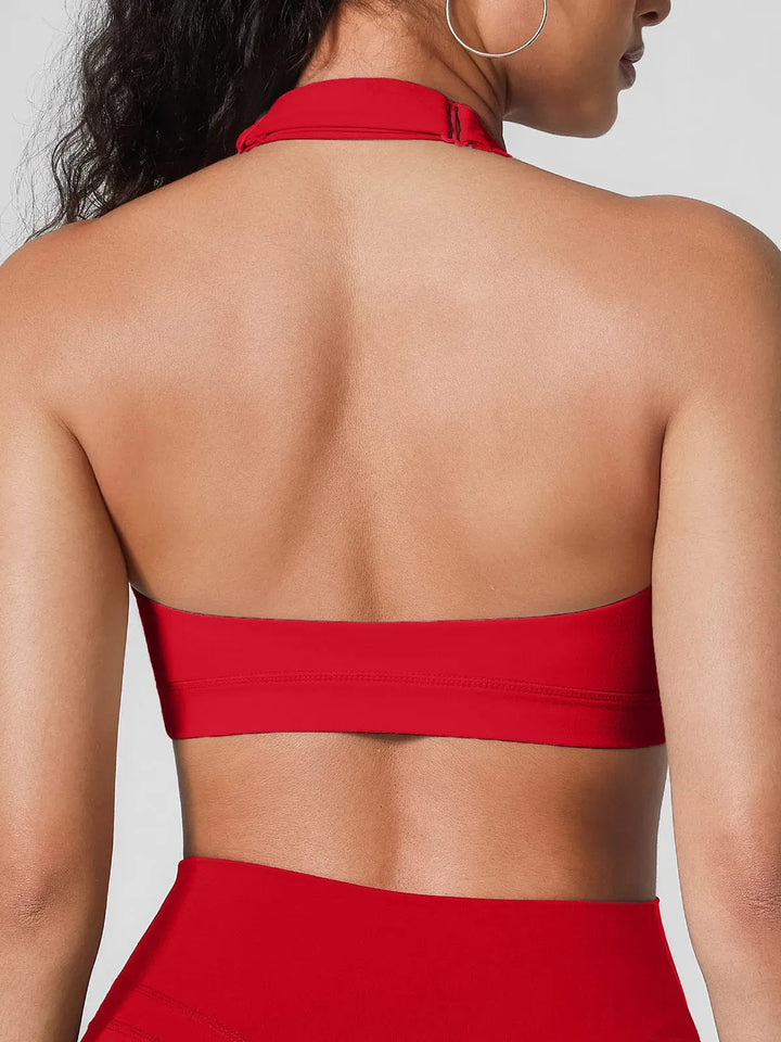 A model wearing a BRXL® Halter-neck Yoga Bra,High Rise Flared Side Pockets Scrunch Leggings in