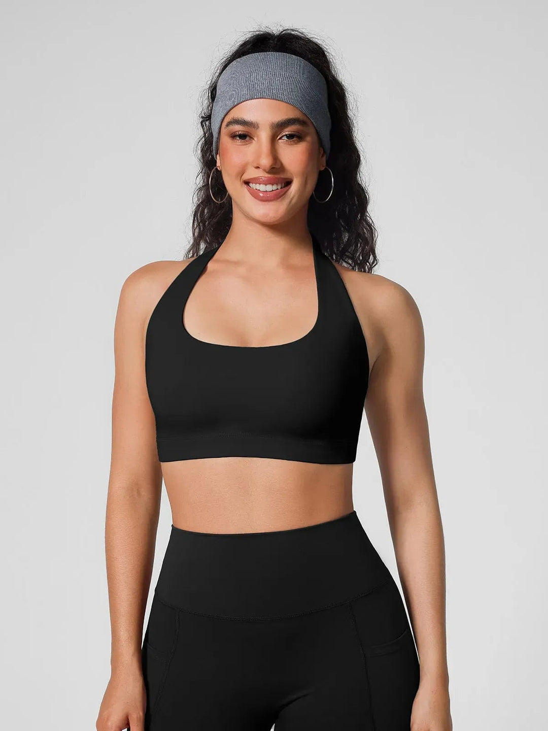A model wearing a BRXL® Halter-neck Yoga Bra,High Rise Flared Side Pockets Scrunch Leggings in
