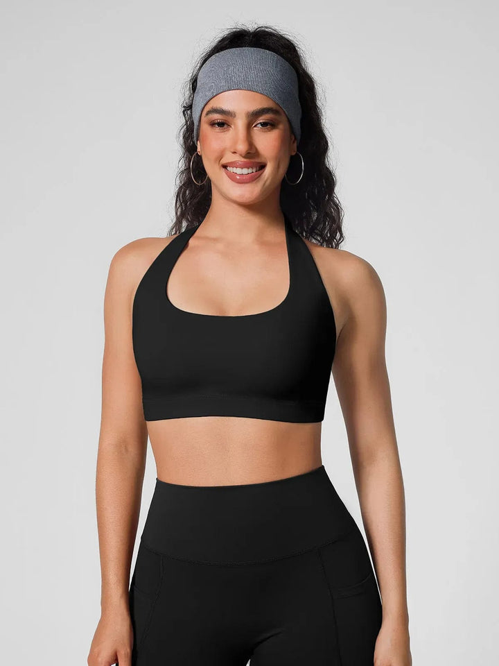 A model wearing a BRXL® Halter-neck Yoga Bra,High Rise Flared Side Pockets Scrunch Leggings in