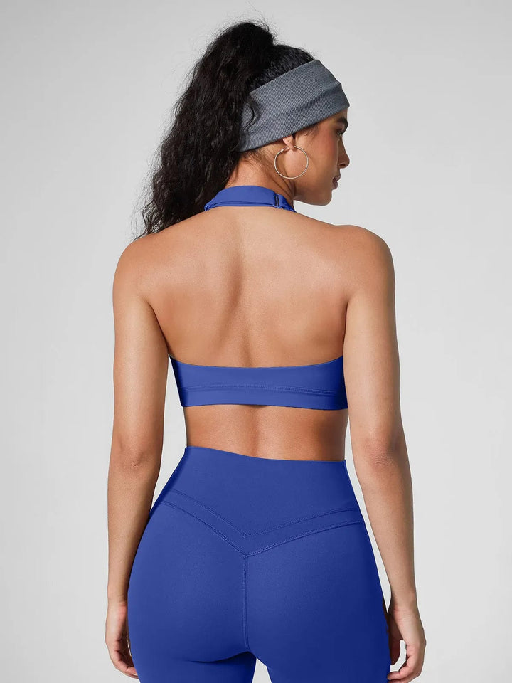 A model wearing a BRXL® Halter-neck Yoga Bra,High Rise Flared Side Pockets Scrunch Leggings in