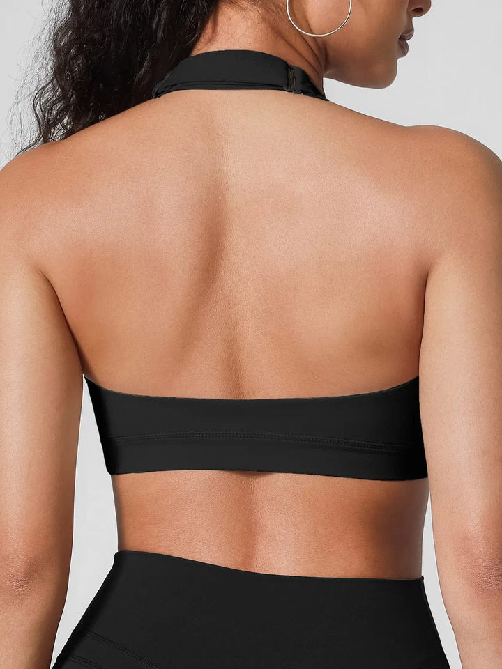 A model wearing a BRXL® Halter-neck Yoga Bra,High Rise Flared Side Pockets Scrunch Leggings in