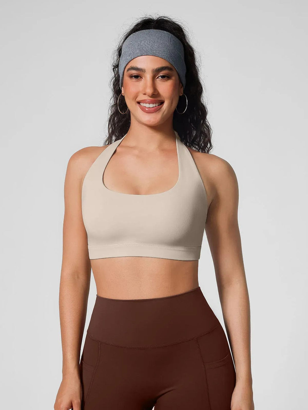 A model wearing a BRXL® Halter-neck Yoga Bra,High Rise Flared Side Pockets Scrunch Leggings in