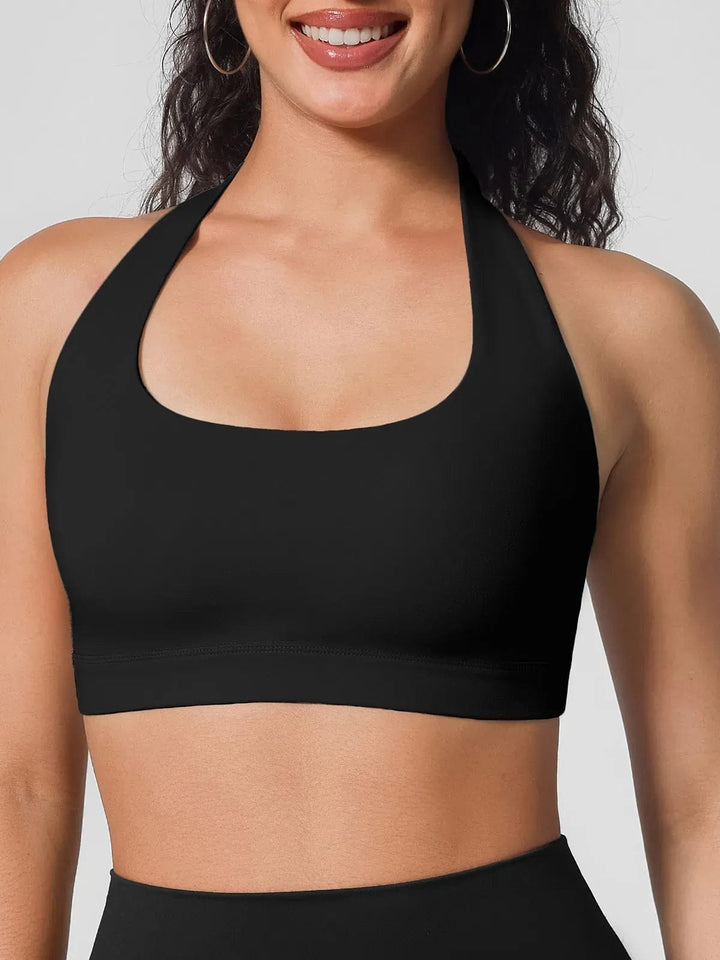 A model wearing a BRXL® Halter-neck Yoga Bra,High Rise Flared Side Pockets Scrunch Leggings in