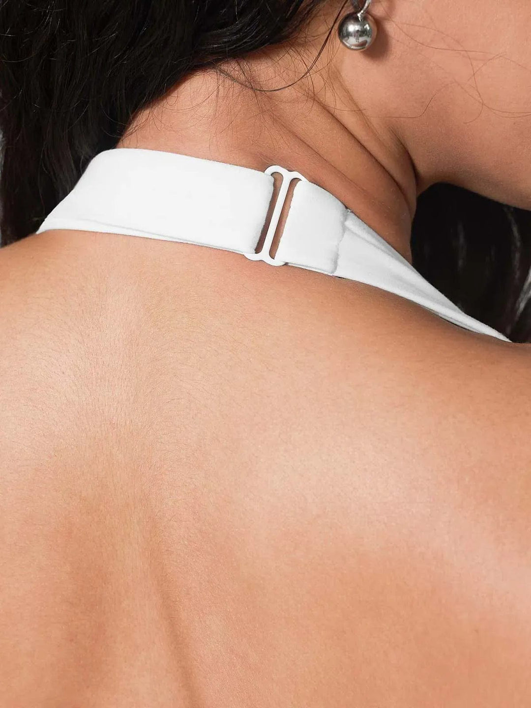 A model wearing a BRXL® Halter-neck Yoga Bra,High Rise Flared Side Pockets Scrunch Leggings in