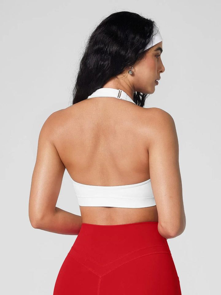 A model wearing a BRXL® Halter-neck Yoga Bra,High Rise Flared Side Pockets Scrunch Leggings in