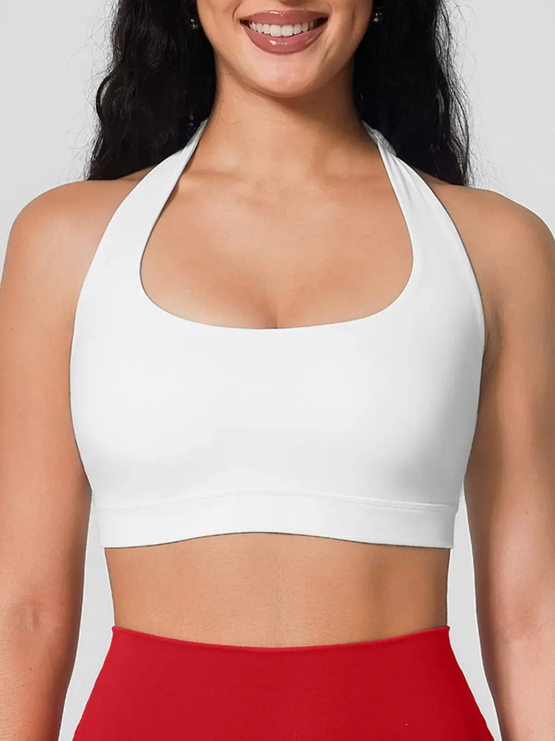 A model wearing a BRXL® Halter-neck Yoga Bra,High Rise Flared Side Pockets Scrunch Leggings in