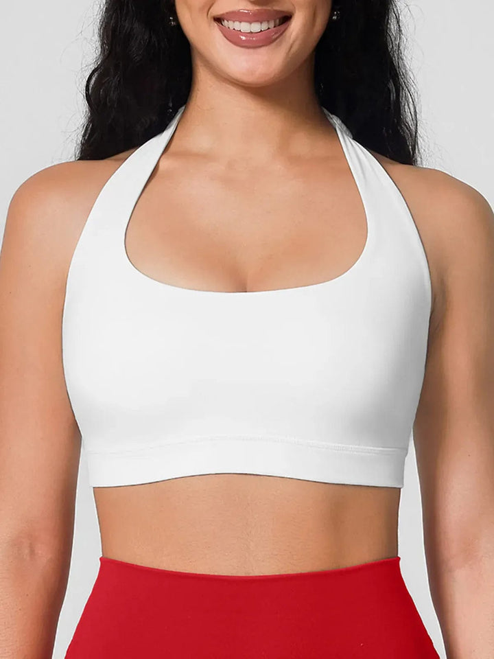 A model wearing a BRXL® Halter-neck Yoga Bra,High Rise Flared Side Pockets Scrunch Leggings in