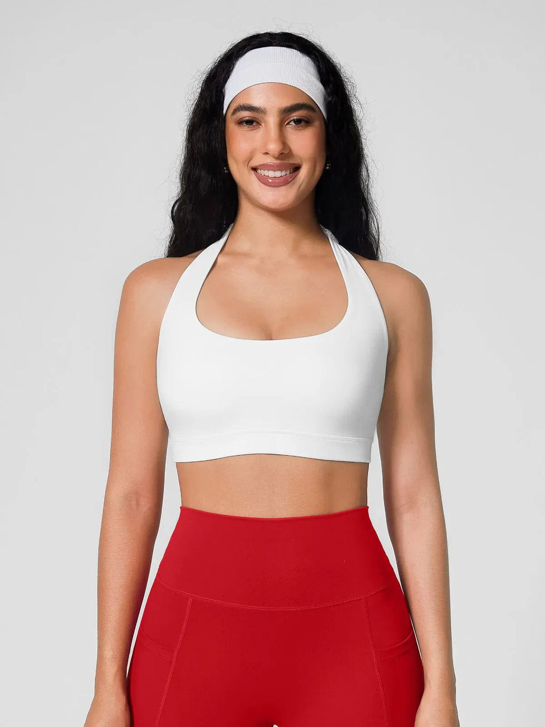 A model wearing a BRXL® Halter-neck Yoga Bra,High Rise Flared Side Pockets Scrunch Leggings in