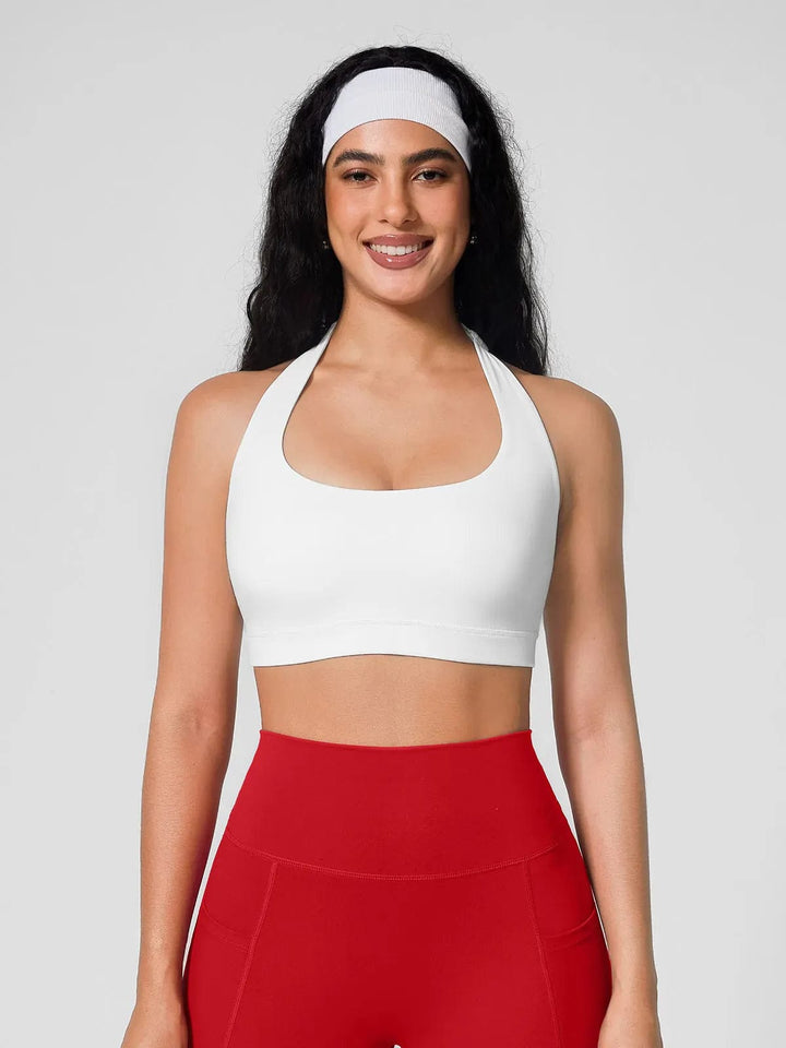 A model wearing a BRXL® Halter-neck Yoga Bra,High Rise Flared Side Pockets Scrunch Leggings in