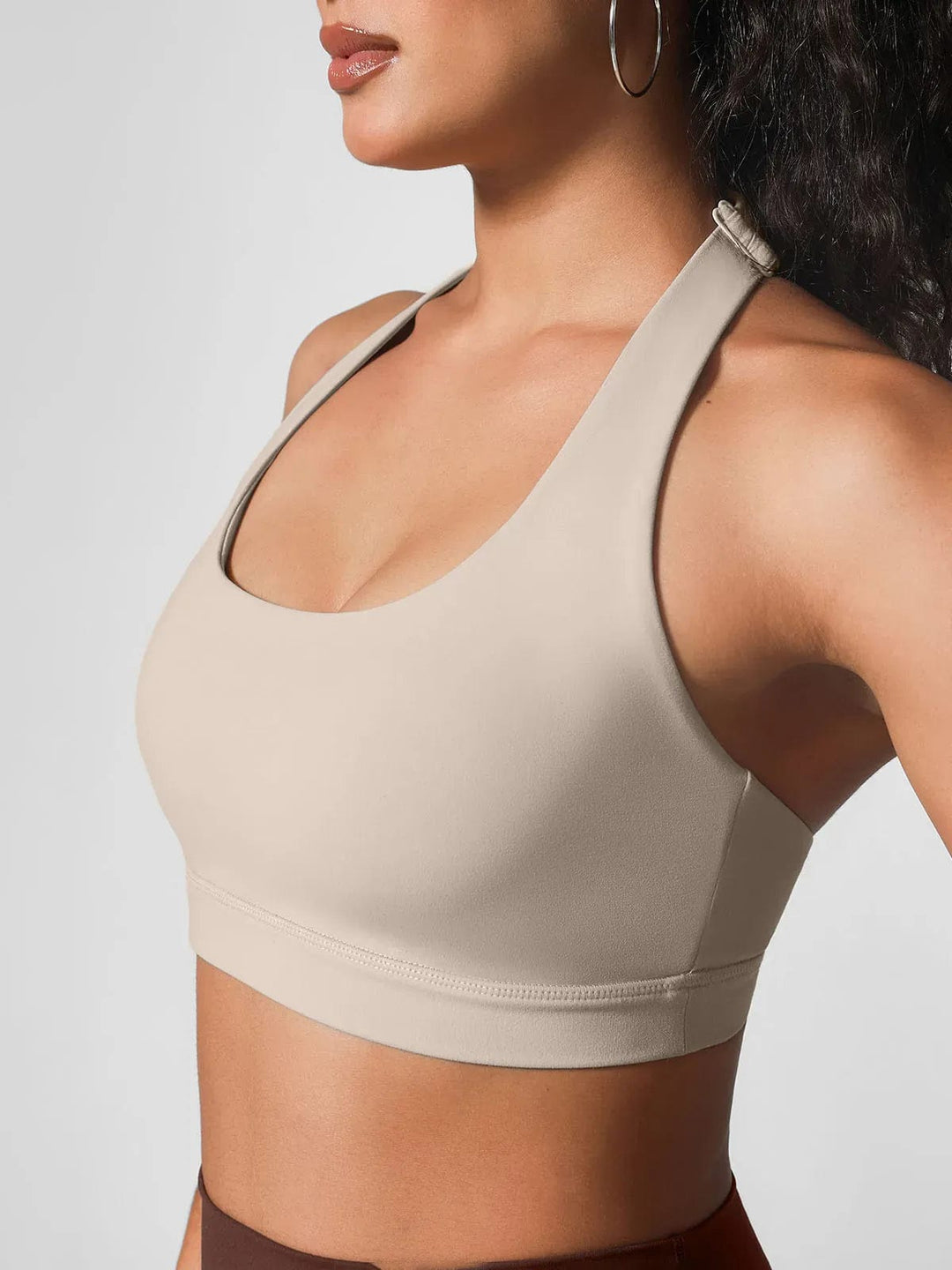 A model wearing a BRXL® Halter-neck Yoga Bra,High Rise Flared Side Pockets Scrunch Leggings in Bra / Brown / XS