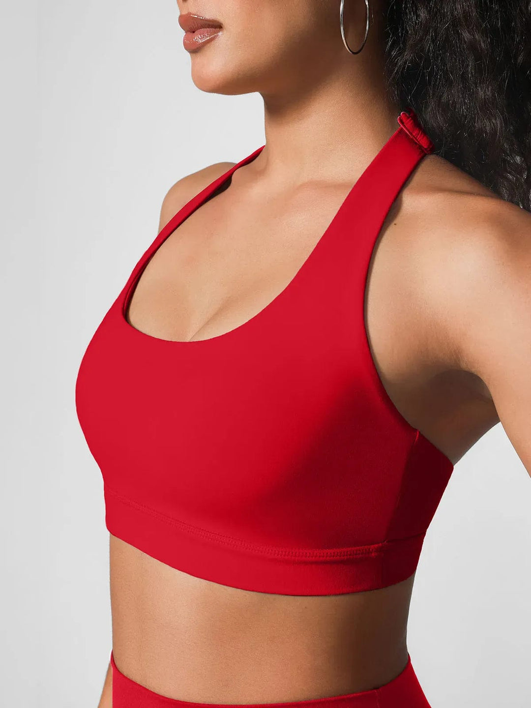 A model wearing a BRXL® Halter-neck Yoga Bra,High Rise Flared Side Pockets Scrunch Leggings in Bra / Red / XS