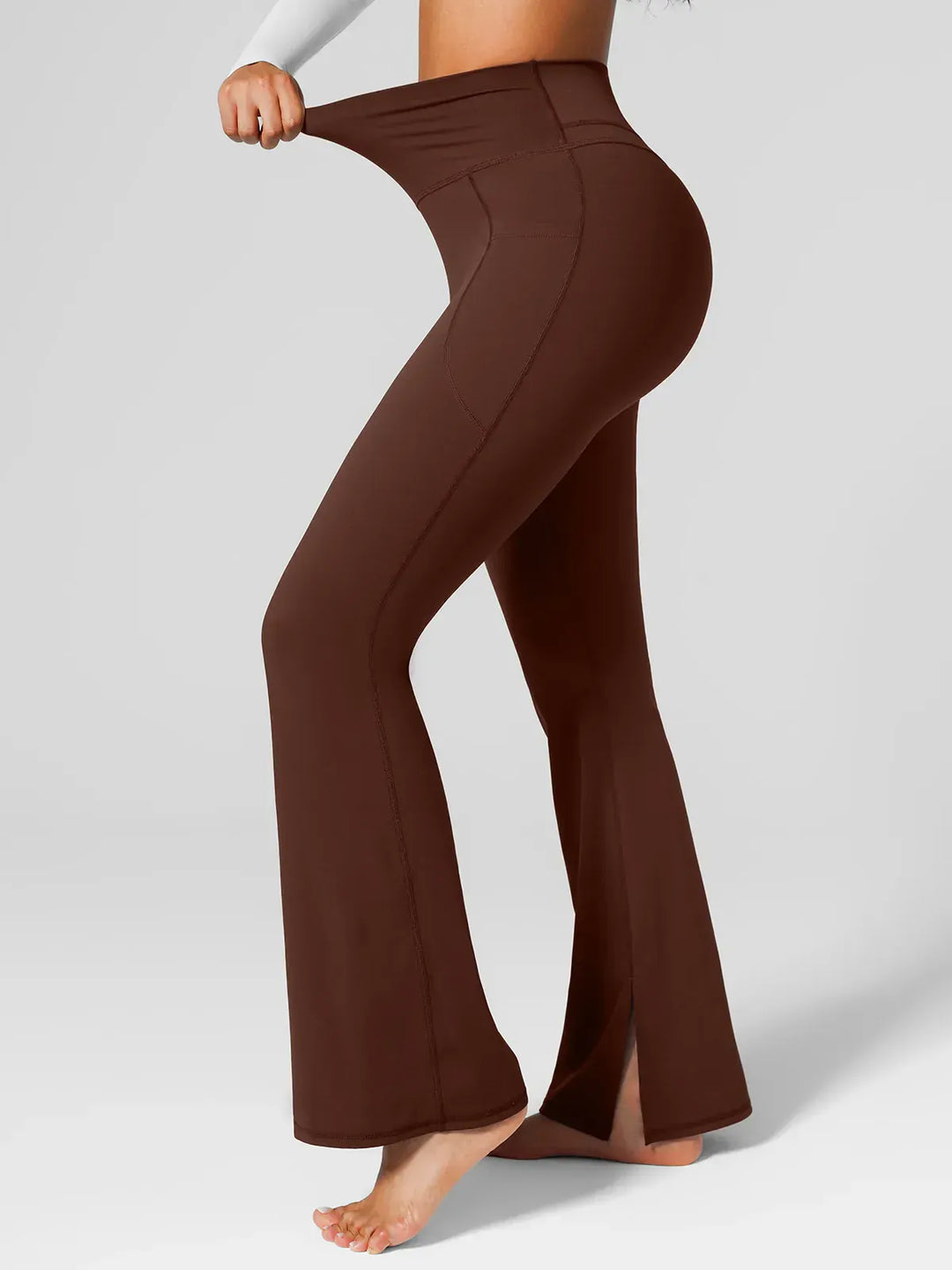 A model wearing a BRXL® High Rise Flared Side Pockets Scrunch Leggings